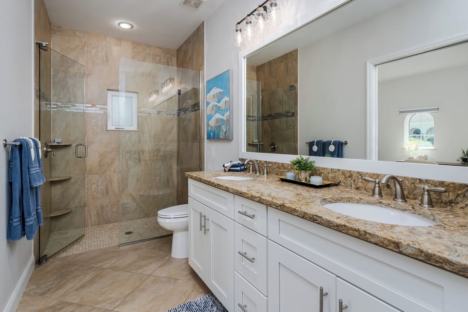 Step into your spa-like bathroom retreat where elegant marble countertops meet a stunning walk-in shower. You'll love starting each morning at the dual vanity with perfect lighting for your daily routine.