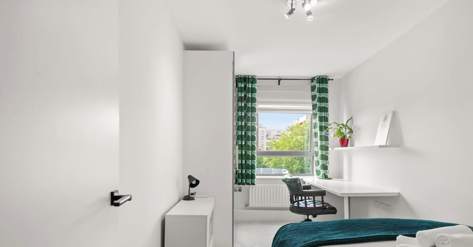 Sunlight fills this inviting bedroom, creating a cheerful and refreshing space where you can recharge and feel at home.