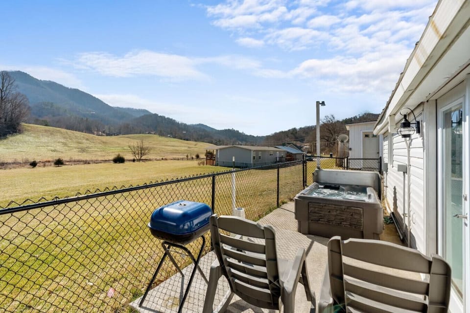 The patio is fenced in and includes outdoor seating and a portable charcoal grill.