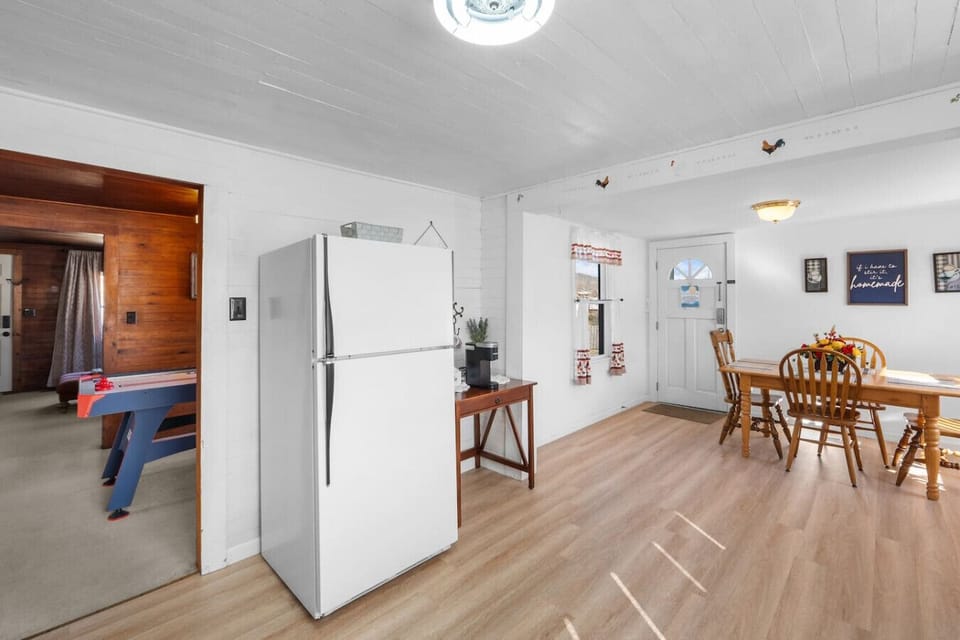 The kitchen includes a coffee bar next to the refrigerator. A Keurig and a standard coffeemaker are both available.