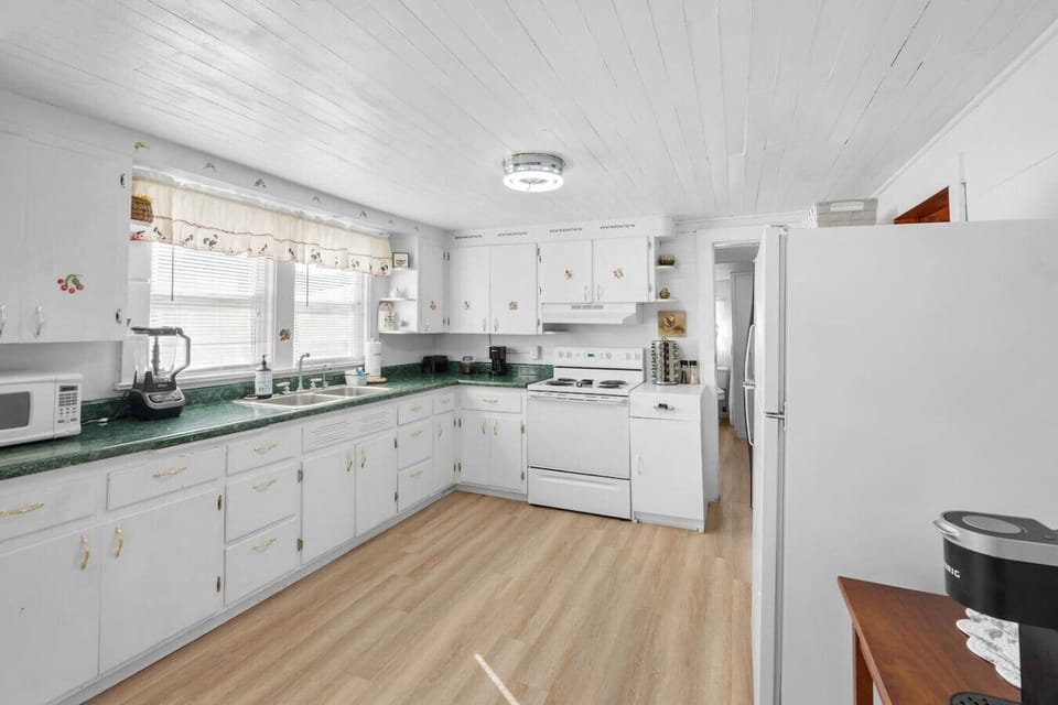 The fully equipped kitchen includes cookware, dishware, bakeware, a coffeemaker, grills tools, and more.