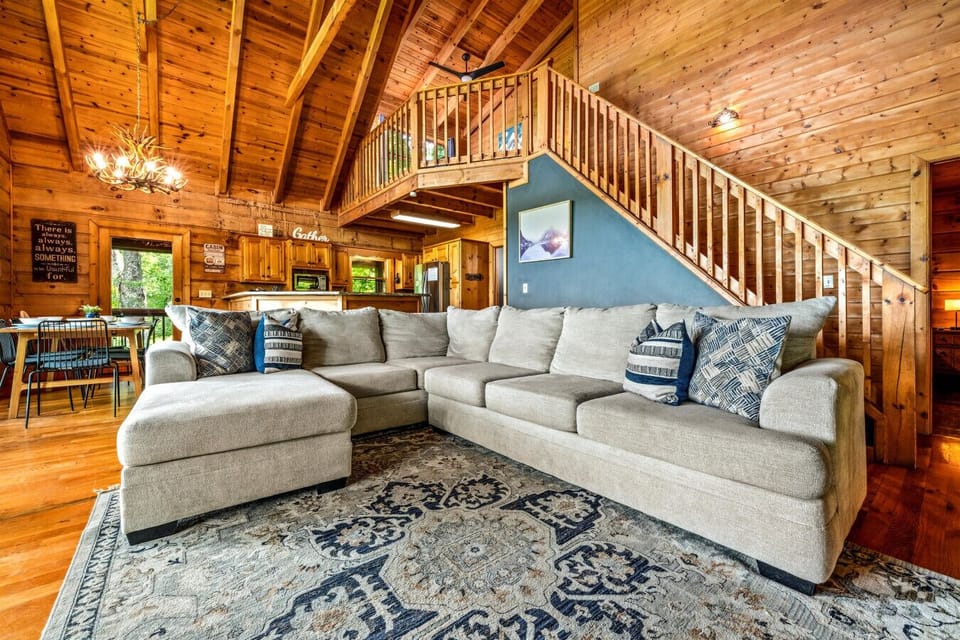 The spacious sectional invites everyone to gather beneath soaring ceilings, creating the perfect spot for movie nights and easy conversation.