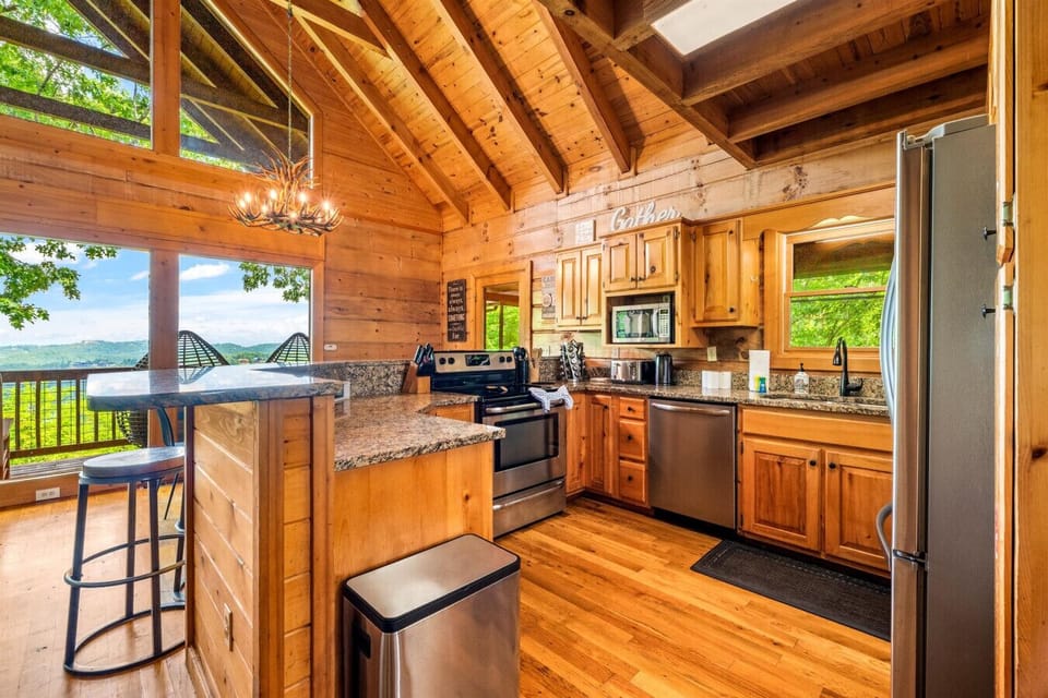 The fully equipped kitchen makes gathering easy, with everything you need to cook, serve, and enjoy meals together—plus mountain views just beyond the door.