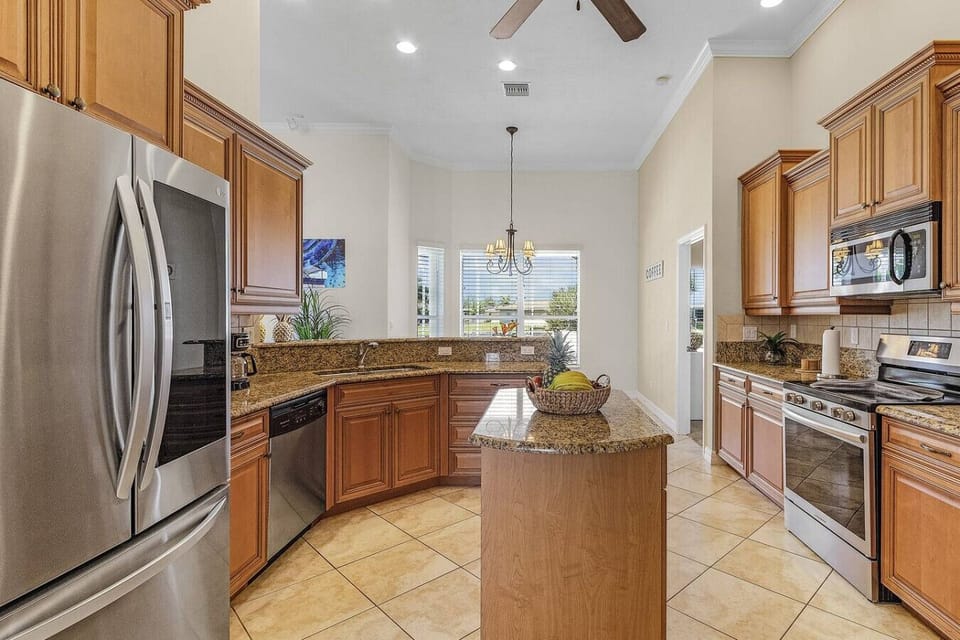 Spacious kitchen with granite countertops and stainless steel appliances, ideal for cooking enthusiasts.