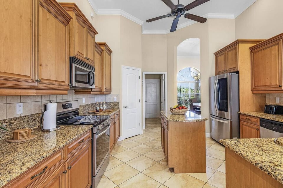 Spacious kitchen with granite countertops and stainless steel appliances, perfect for gourmet cooking.