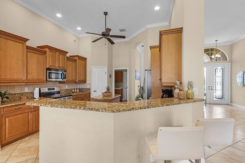 Spacious kitchen with granite countertops and bar seating, perfect for entertaining.