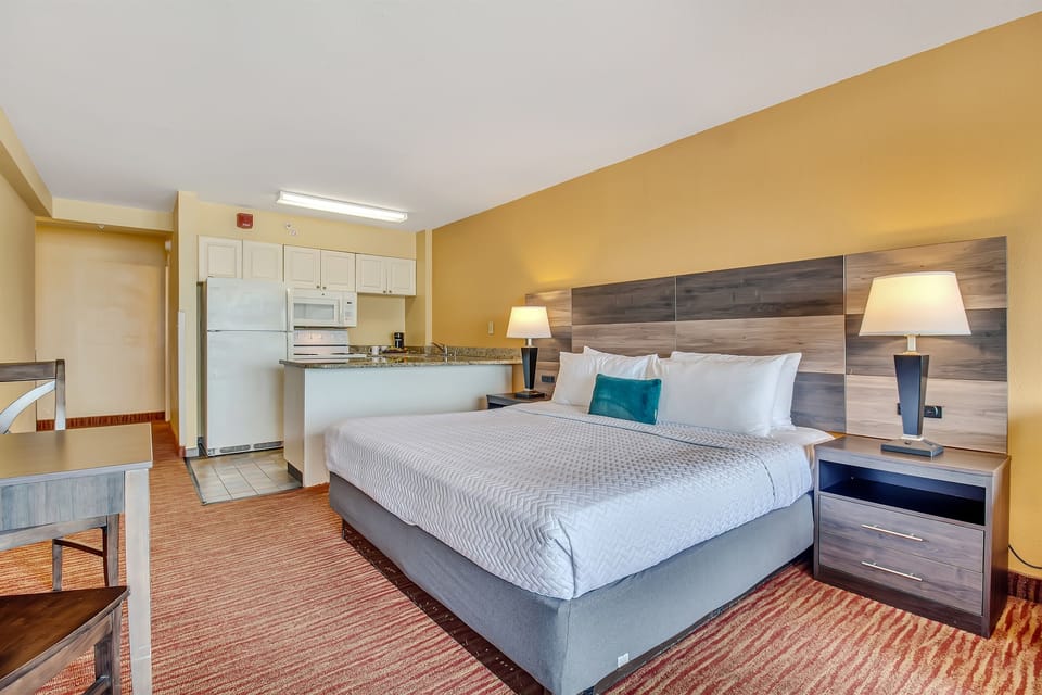 The bed is complemented by an elegant headboard that adds a touch of sophistication to your surroundings. It's not just a place to rest; it's a focal point that enhances the overall ambiance.