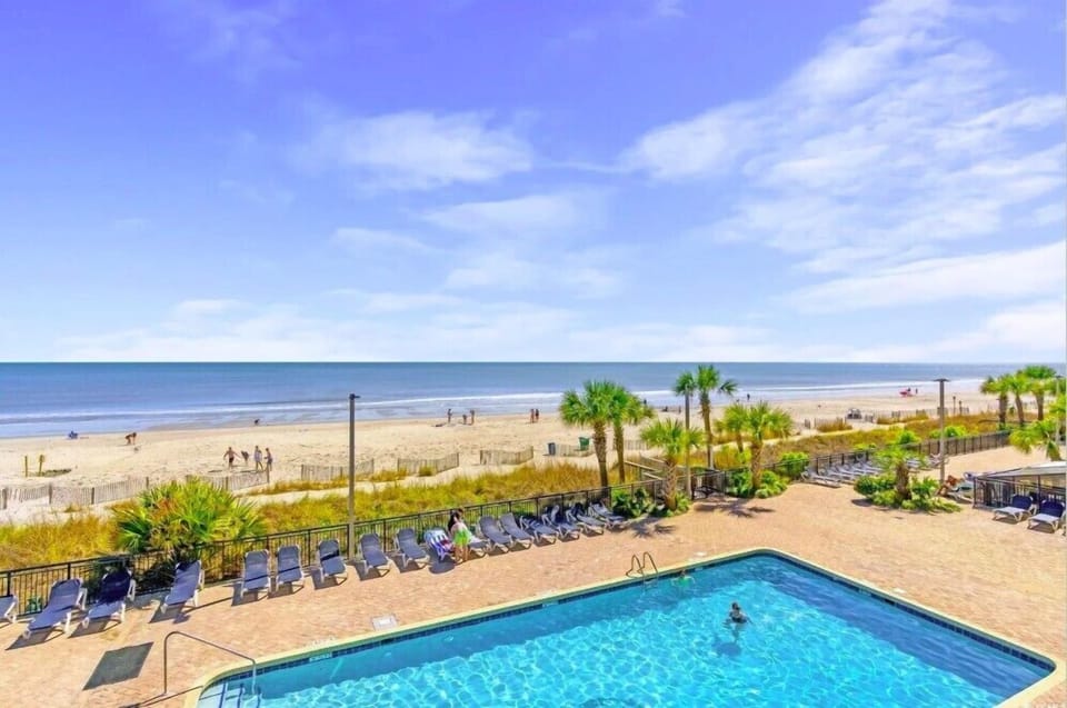 Behold the breathtaking view, where the azure waters of the pool seamlessly blend with the vast expanse of the ocean, creating a true seaside paradise.