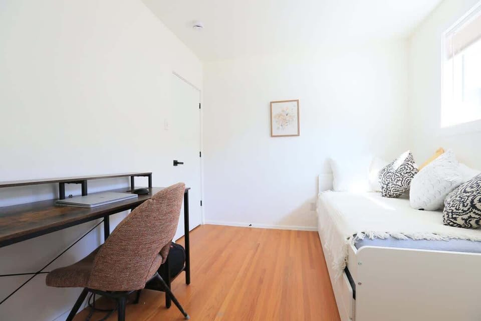 The workspace is located in the bedroom with the trundle bed