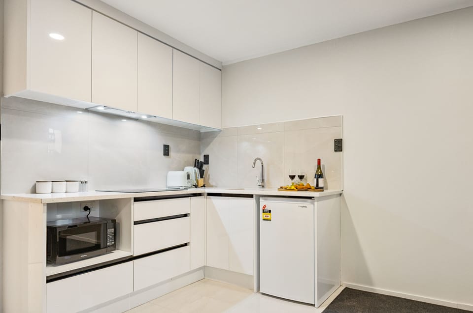 Luxury Suite, 1 Queen Bed | Private kitchen | Fridge, microwave, stovetop, cookware/dishes/utensils