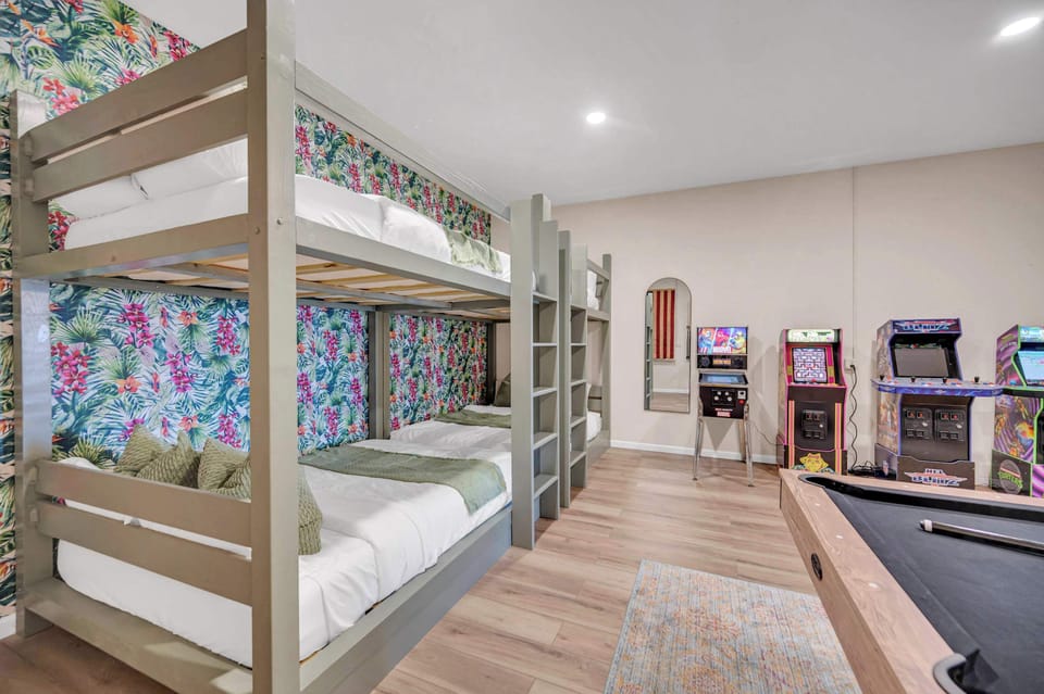 Game on and lights out—all in the same space! With queen bunks, 4 arcades, and a pool table, this room is every kid’s (and kid-at-heart’s) dream!