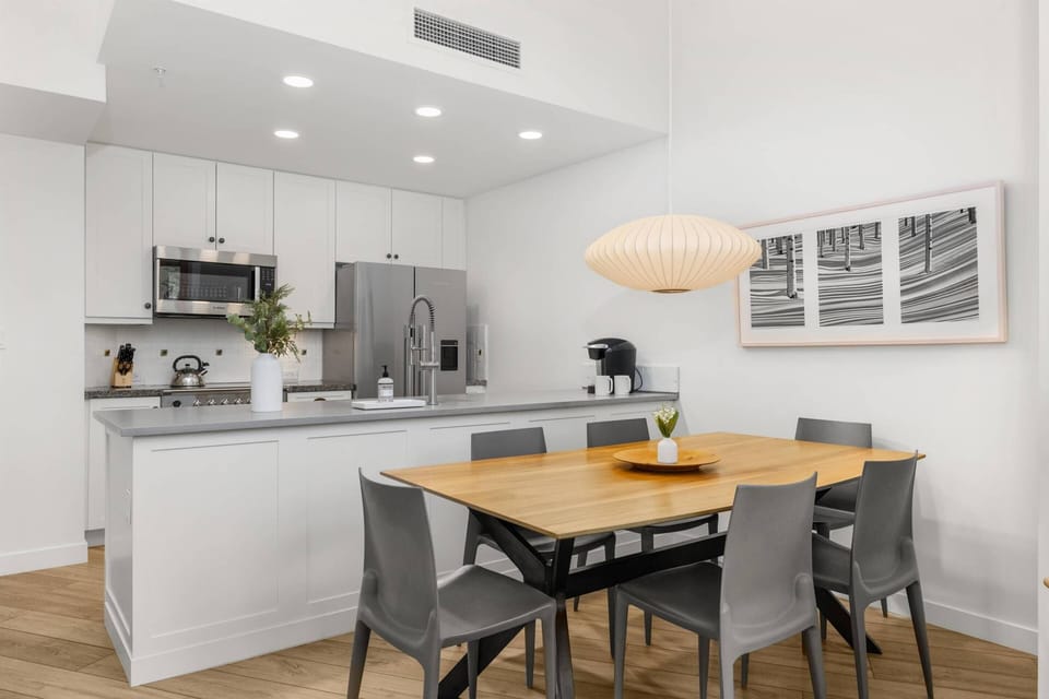 The brand new kitchen has stainless steel appliances and a dining table where you can enjoy meals together during your stay!