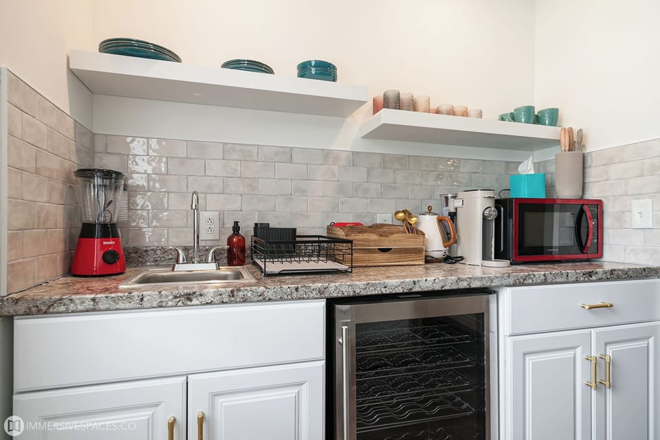 Prepare your favorite snacks in this well-equipped kitchenette, featuring modern appliances, ample counter space, and stylish cabinetry.
