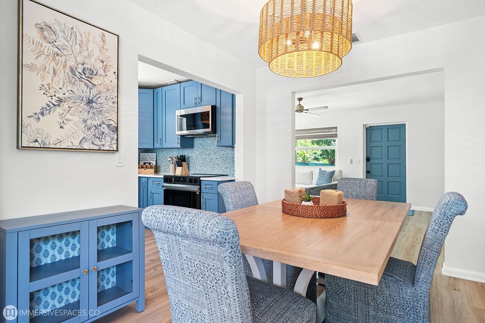 A charming dining nook bathed in natural light, featuring a round table, comfortable chairs, and easy access to the adjacent kitchen area.

