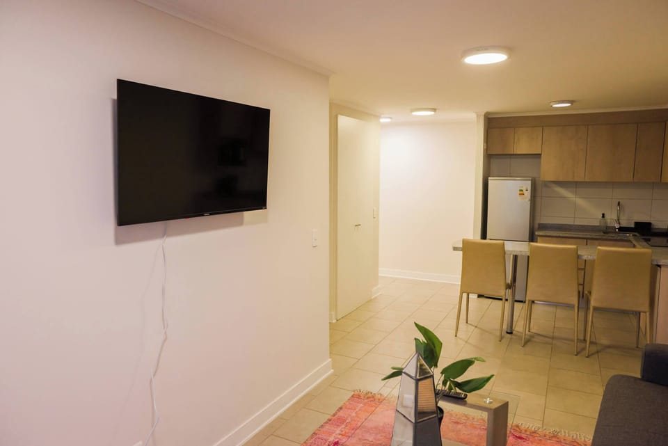 Cozy living area with modern amenities and a sleek kitchen, perfect for a relaxing stay.