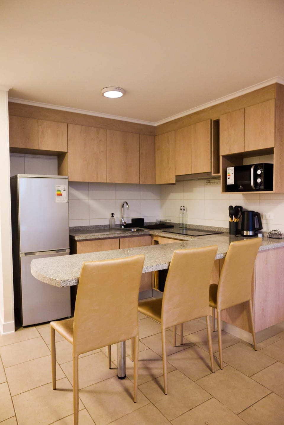 Cozy and modern kitchen with all essentials for a comfortable stay in this studio apartment.