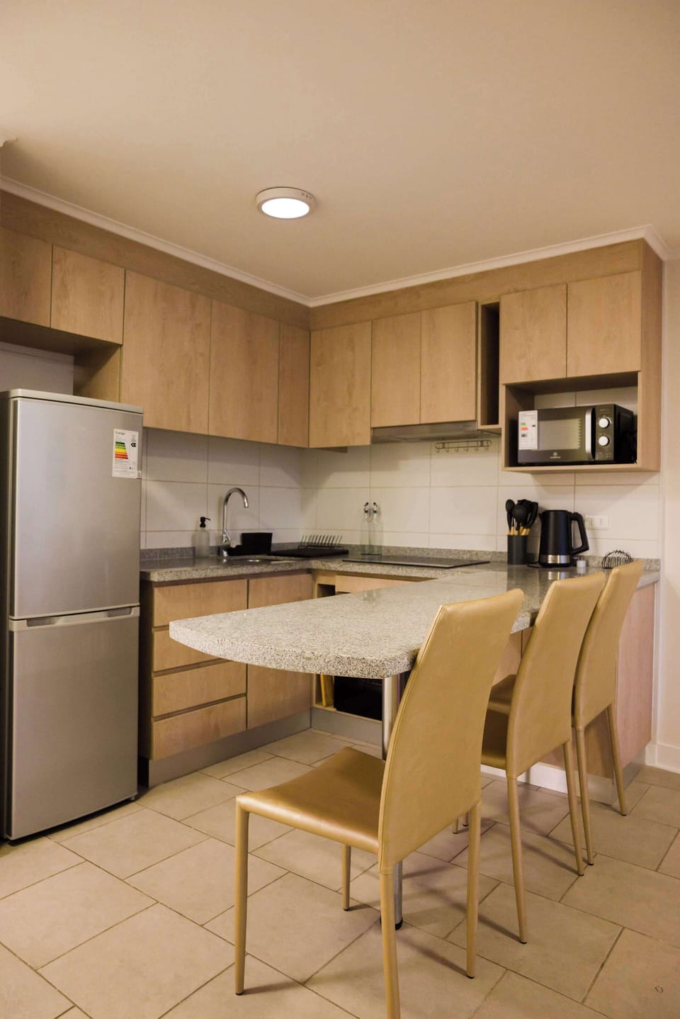 Cozy kitchen with modern amenities and a convenient dining area, perfect for a comfortable stay.