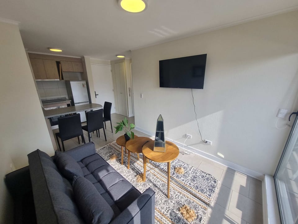 Cozy living area with modern decor, natural light, and a convenient dining space perfect for relaxing or entertaining.