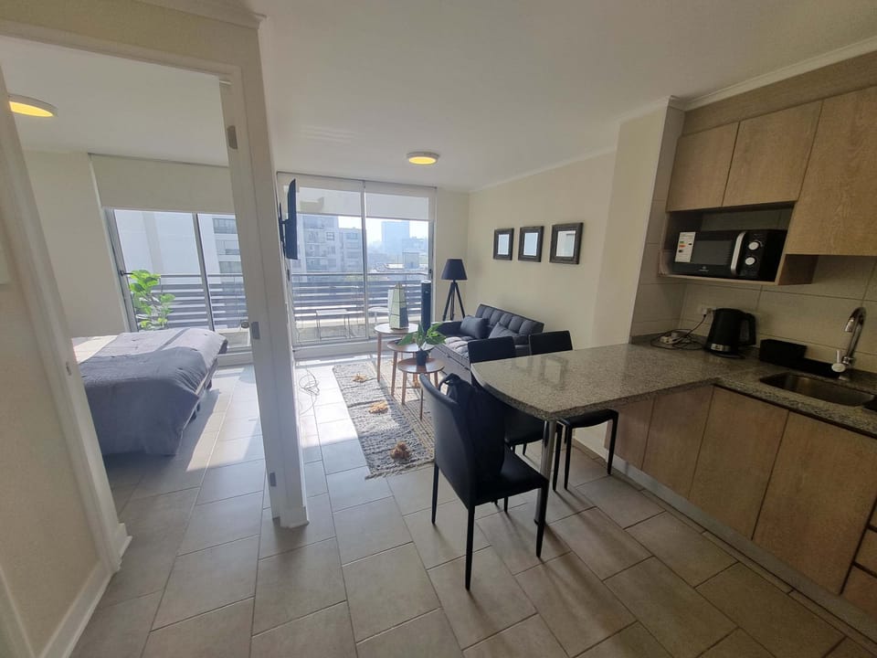 Bright and cozy studio with a modern kitchen and a balcony view, perfect for a relaxing stay in the city.