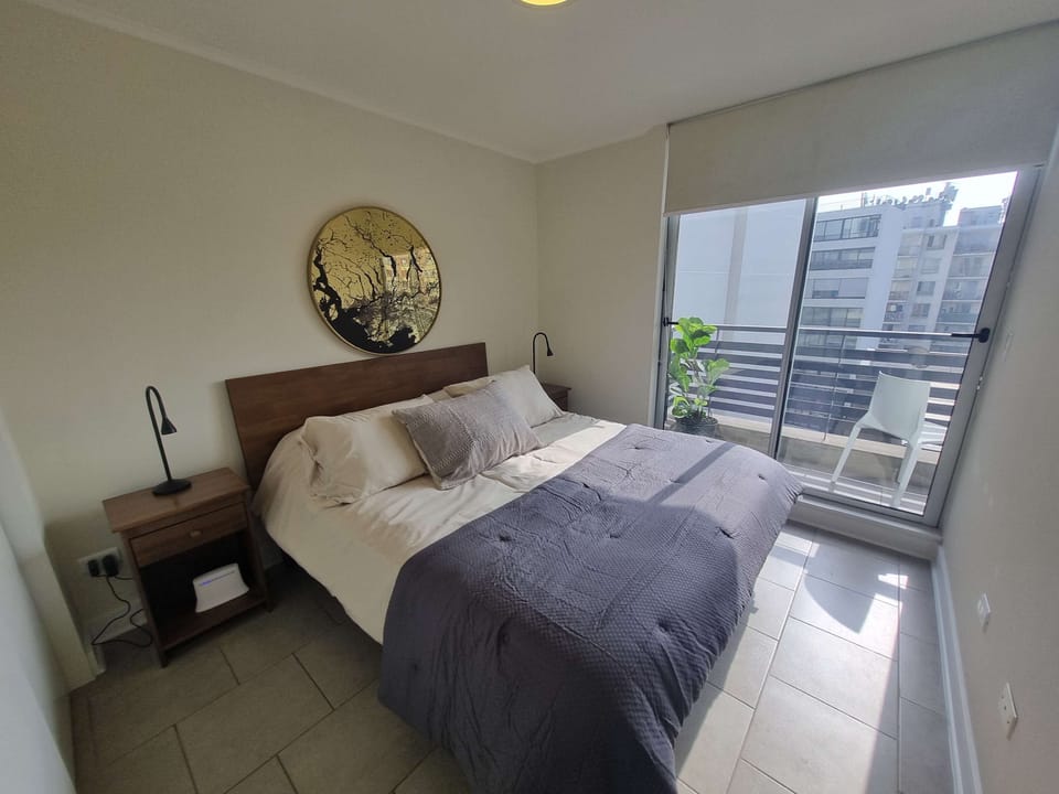 Relax in this cozy bedroom with a private balcony offering city views, perfect for unwinding after a day of exploring.
