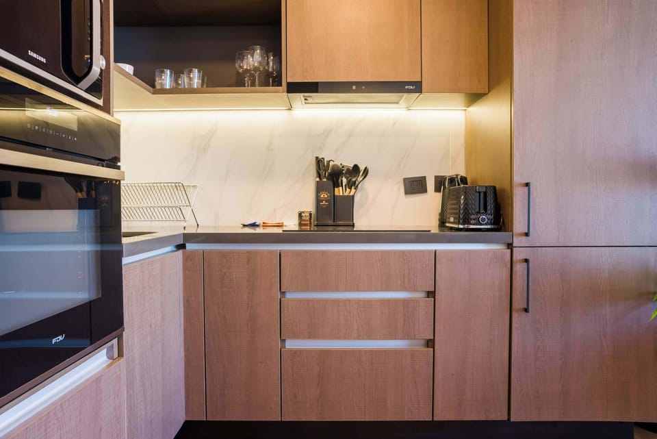 Sleek and modern kitchen with top-notch appliances and ample storage, perfect for culinary enthusiasts.