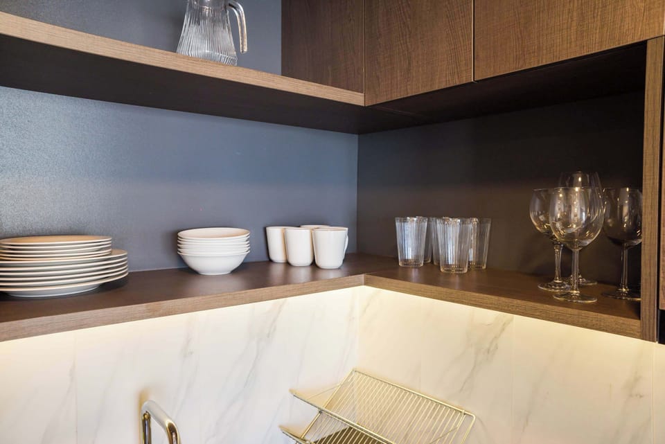 Stylish kitchen with open shelving and elegant dishware, perfect for a cozy meal at home.