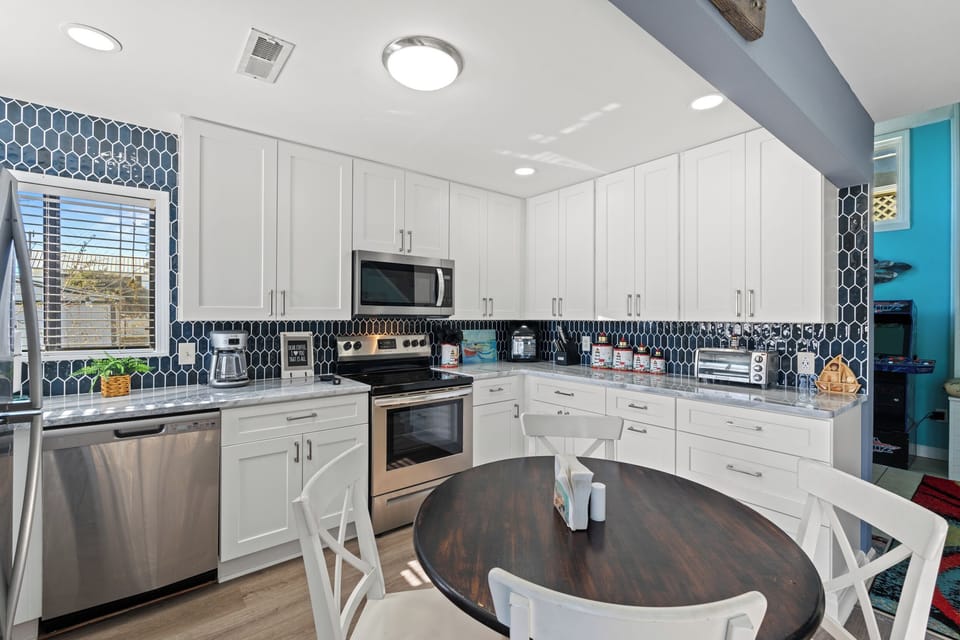 Your fully equipped kitchen features modern appliances, stylish hexagon tile backsplash, and plenty of counter space for preparing memorable meals together.