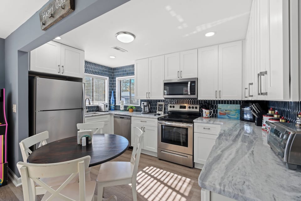 Your fully equipped kitchen awaits with modern appliances, marble countertops, and a cozy breakfast nook where you can savor your morning coffee.