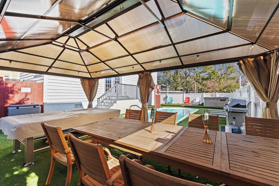 Your private covered dining area features elegant teak furniture where you can enjoy meals while overlooking the sparkling pool.