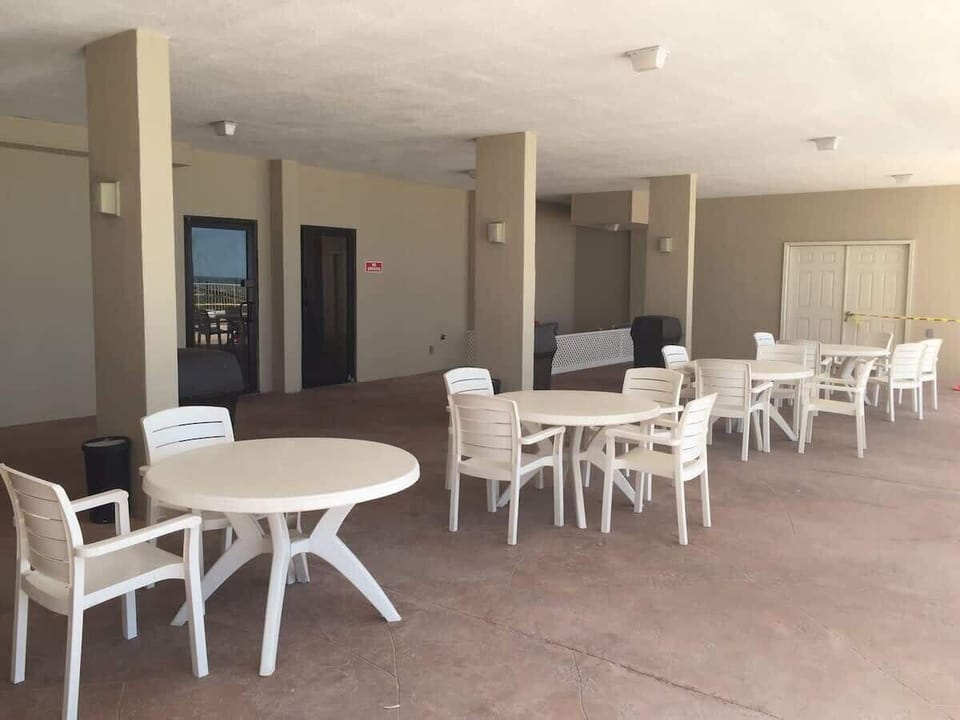 Shady community spot overlooking the pool and beach! Newly painted floors!