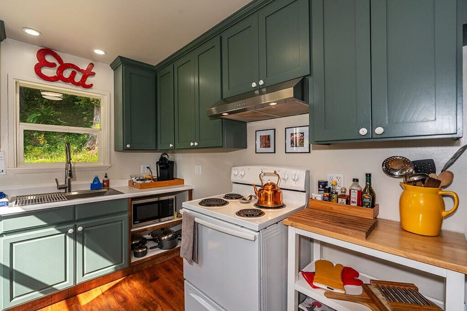 The kitchen has a 4 burner electric stove, microwave and is well