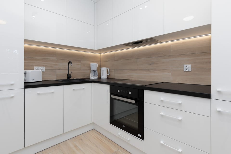 The sleek design of the kitchenette blending seamlessly with the living area.