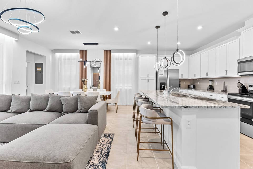 Discover the charm of this inviting living space with a cozy sectional sofa for relaxation. The sleek kitchen boasts polished granite countertops and modern fixtures, seamlessly connecting to the dining area, perfect for.