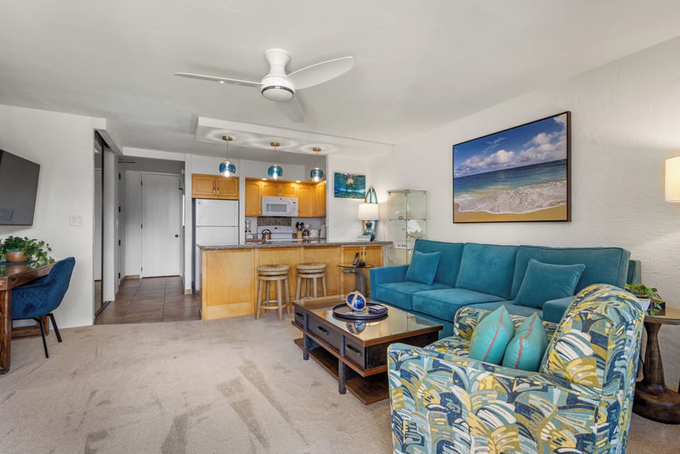 Unwind in your bright coastal retreat with comfy seating, beach-inspired accents, and a breeze from the ceiling fan overhead.