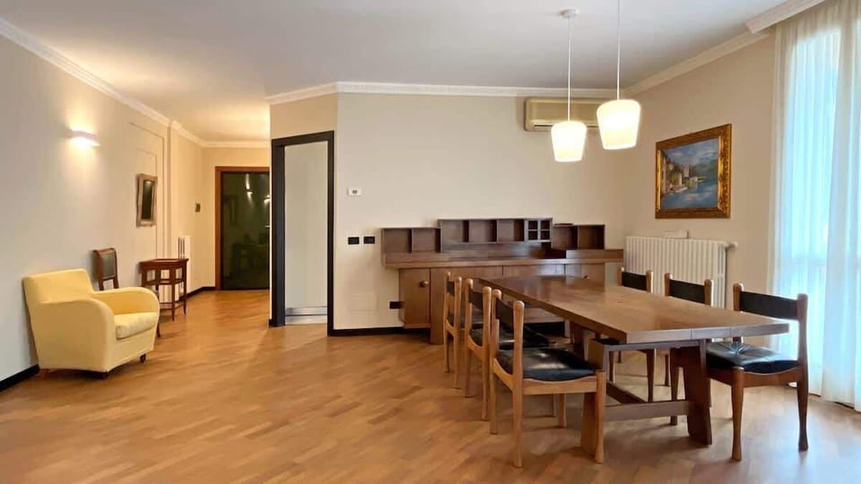 spacious, bright, cozy and elegant dining room, perfect for moments in company, at the center the wwoden table and chairs that guarantee comfort and a correct posture
