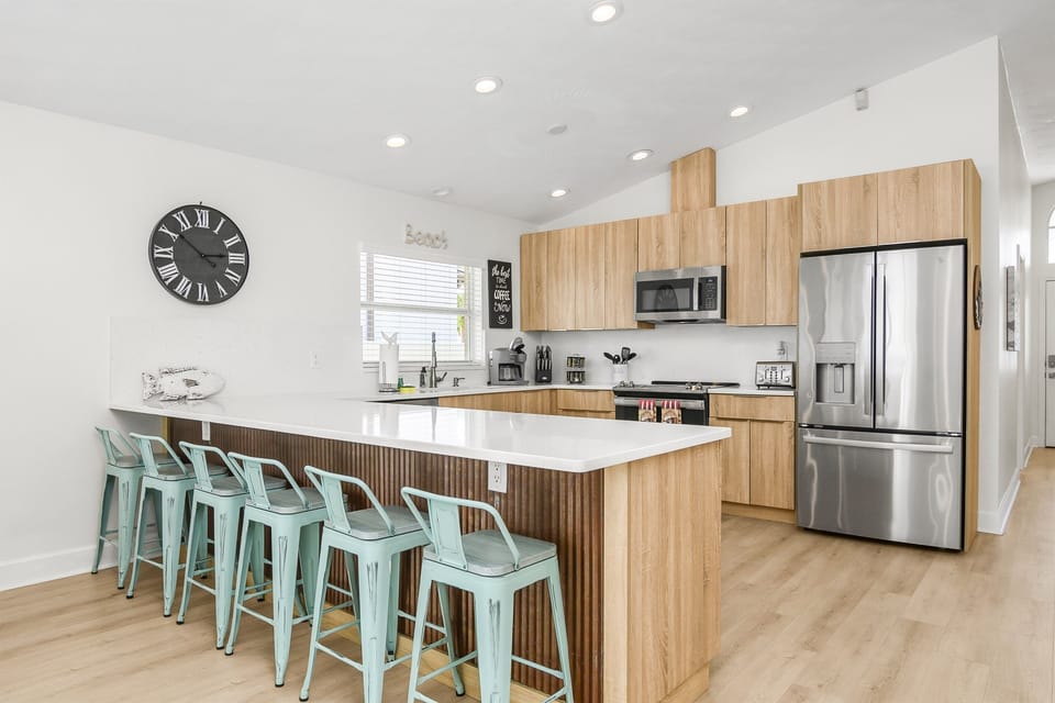 The kitchen is fully updated with brand-new appliances and a spacious island that comfortably seats up to six—perfect for casual meals and gatherings