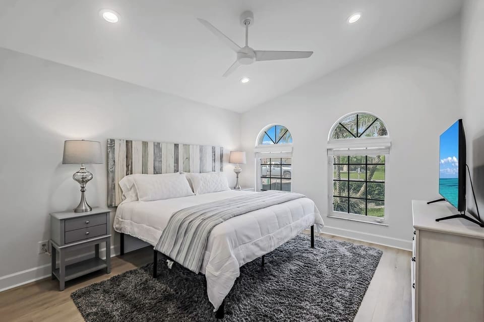 This spacious second bedroom offers a king-size bed, smart TV, ceiling fan, ample closet space, and a cozy chair for relaxing (not in a picture). 