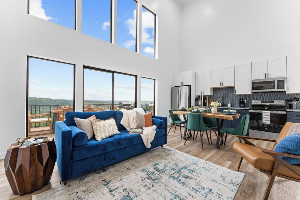 Gather with family in this bright, open-concept living and kitchen area featuring panoramic views, vaulted ceilings and stylish modern finishes. This Branson family vacation home is just minutes from top Branson, MO attractions, shows, and lake adventures!