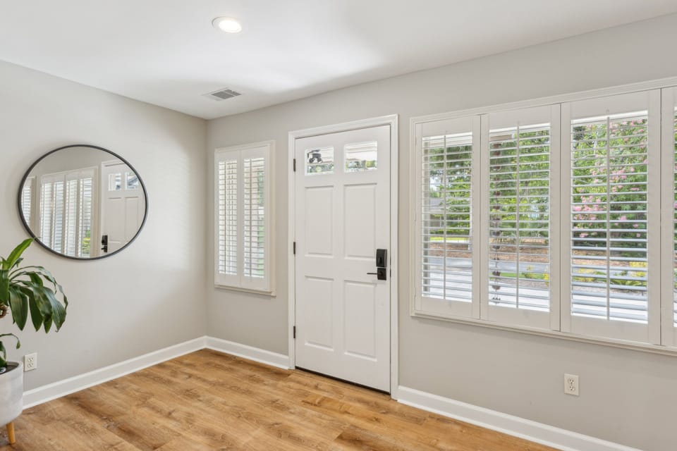 A welcoming front entrance sets the tone for this lovely home. Many windows invite natural light into the foyer.