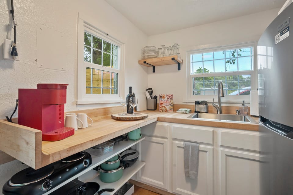 Perfect for light cooking with a full-size fridge, microwave, hot plate, and essentials.