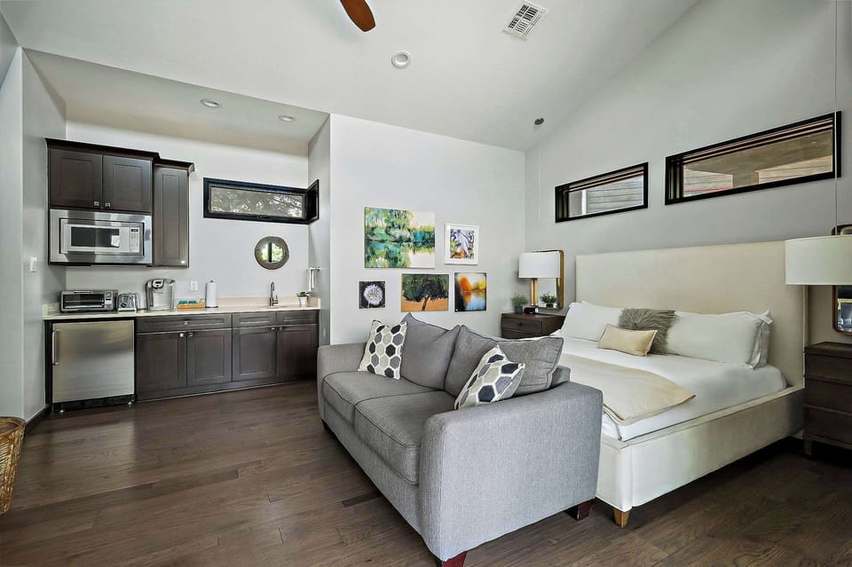 The inviting main living area features a king-size bed, a queen sofa bed large TV, and a cozy fireplace, ideal for unwinding after a day at the lake.