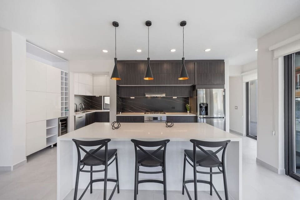 Sleek, modern, and made for gathering—this kitchen is the heart of the home, whether you`re cooking up a feast or just enjoying coffee at the island.