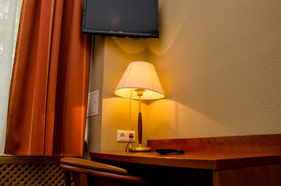 Hypo-allergenic bedding, desk, laptop workspace, blackout drapes