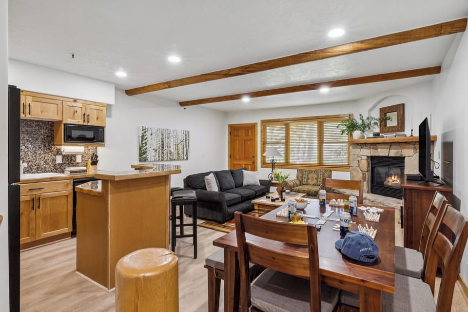 Alternate angle of the living room with full view of the fireplace and dining area.