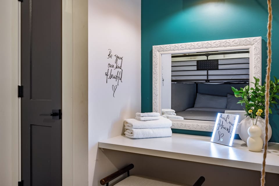 Bedroom with Full-over-Full bunk bed, TV, desk, and shared bathroom access.
