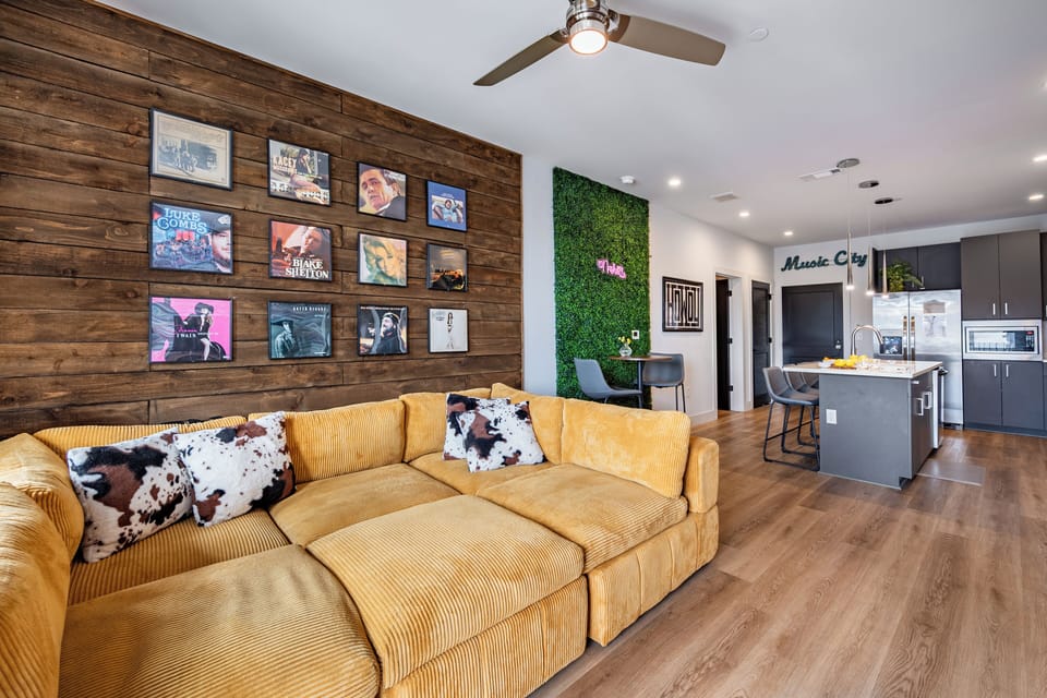Spacious living room with an art wall and comfortable seating.