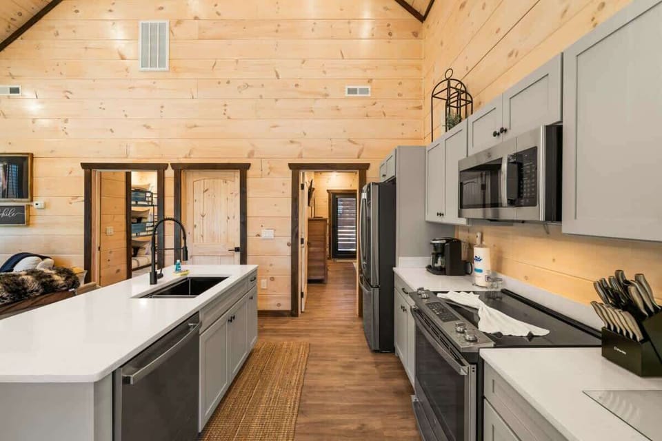 Complete with dishwasher, oven, stove, fridge, freezer, microwave, toaster, coffee machine, blender, cook/bakeware, dishes, cups, mugs, silverware, and even tupperware so you can keep your meals. 