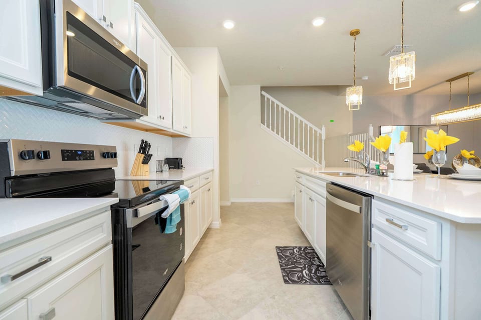 Prepare delicious meals in a contemporary kitchen with top-notch appliances, generous counter space, and a sleek, inviting design.