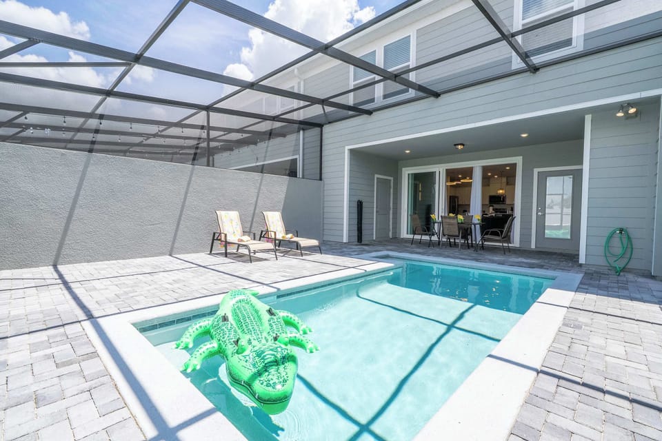 Unwind in your private screened patio with a sparkling pool, comfy loungers, and a playful float-perfect for sunny days and al fresco dining!