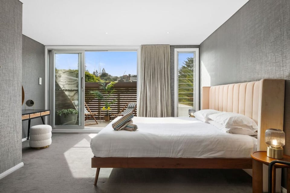 Bedroom 1 with a king-size bed, ensuite, and courtyard